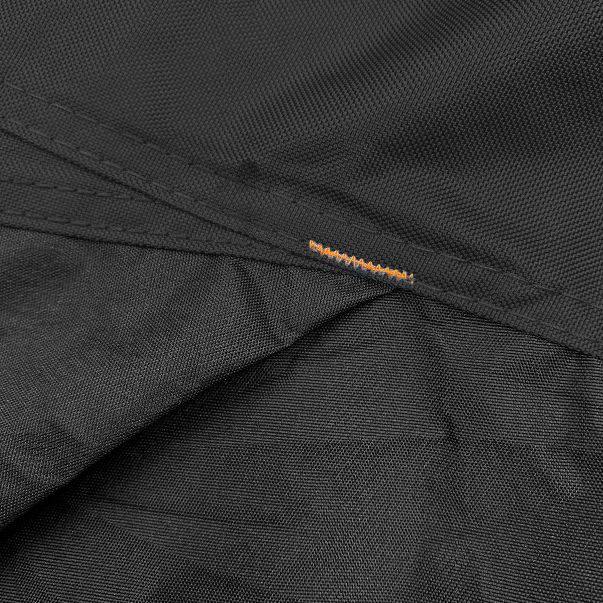 Close-up of black reinforced corners on a vehicle cover, designed to improve durability, prevent wear and tearing, provide extra strength for protection against abrasion, and extend cover lifespan.
