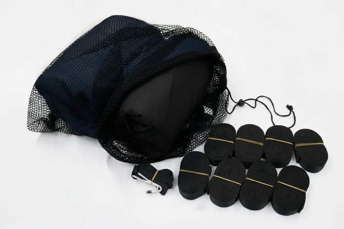 A black mesh drawstring storage bag with several rolled black items tied with thin bands, arranged on a plain white background.