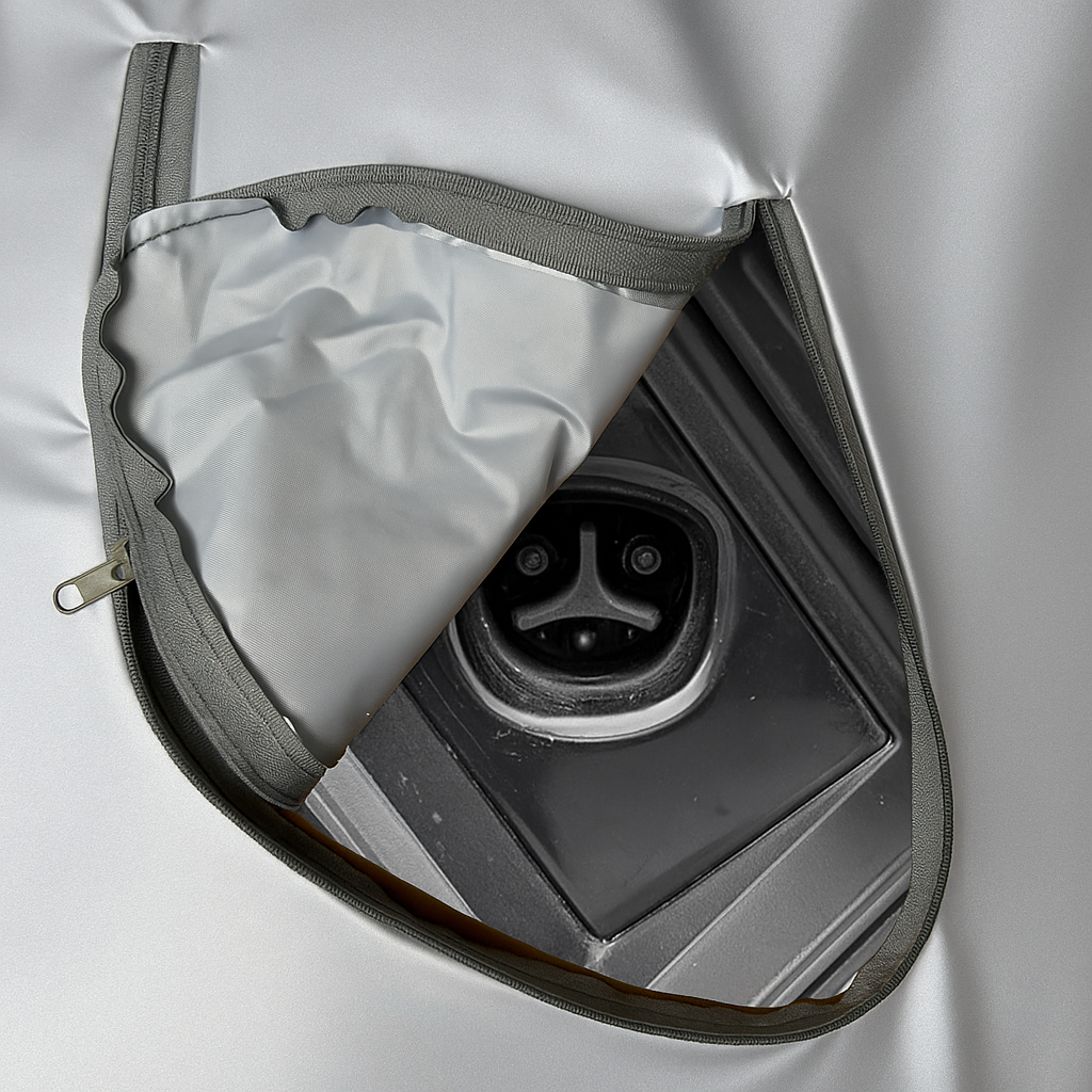 Close-up of a tesla cybertrucks charging port with a gray cover partially open.