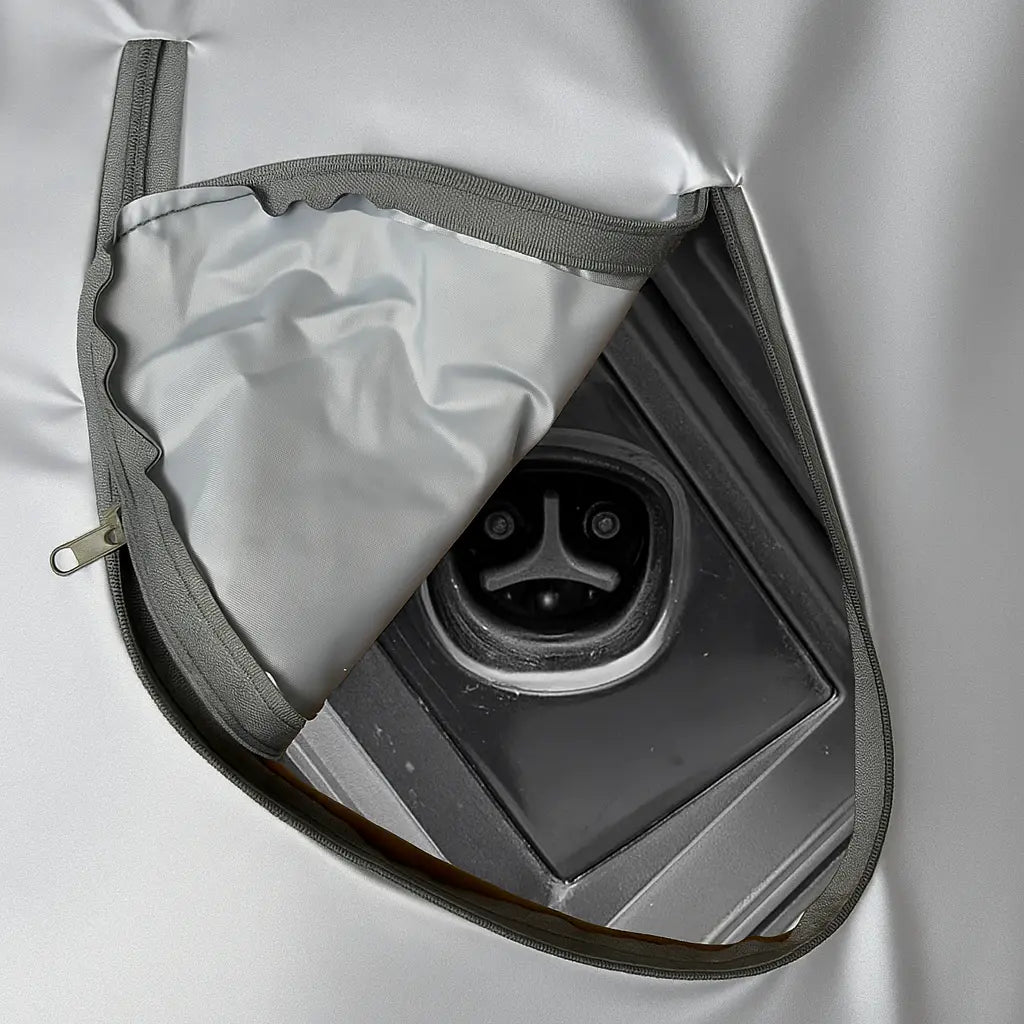 Close-up of a tesla cybertrucks charging port with a gray cover partially open.