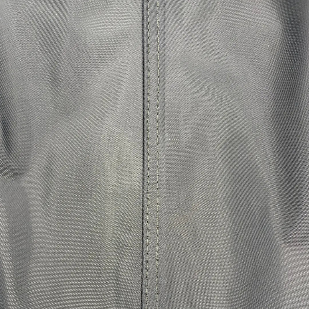 Extreme close-up view of the double-stitched reinforced seam on SavvyCraft green waterproof chest waders, showcasing the durable textile weave and heavy-duty manufacturing.
