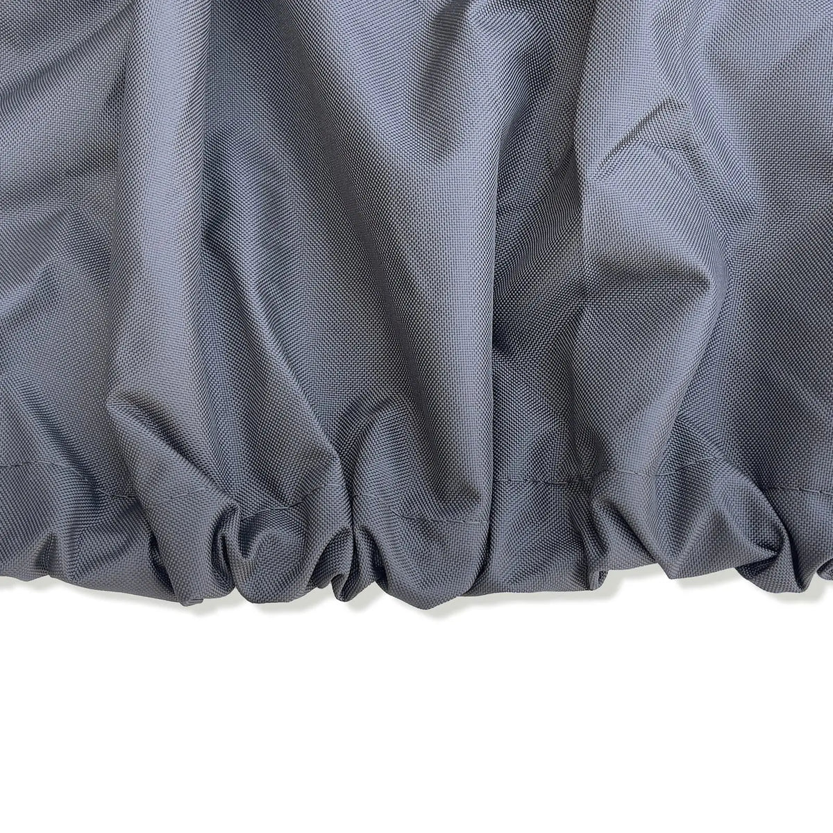 Close-up of gray fabric with a textured pattern on a white background showing elastic hems