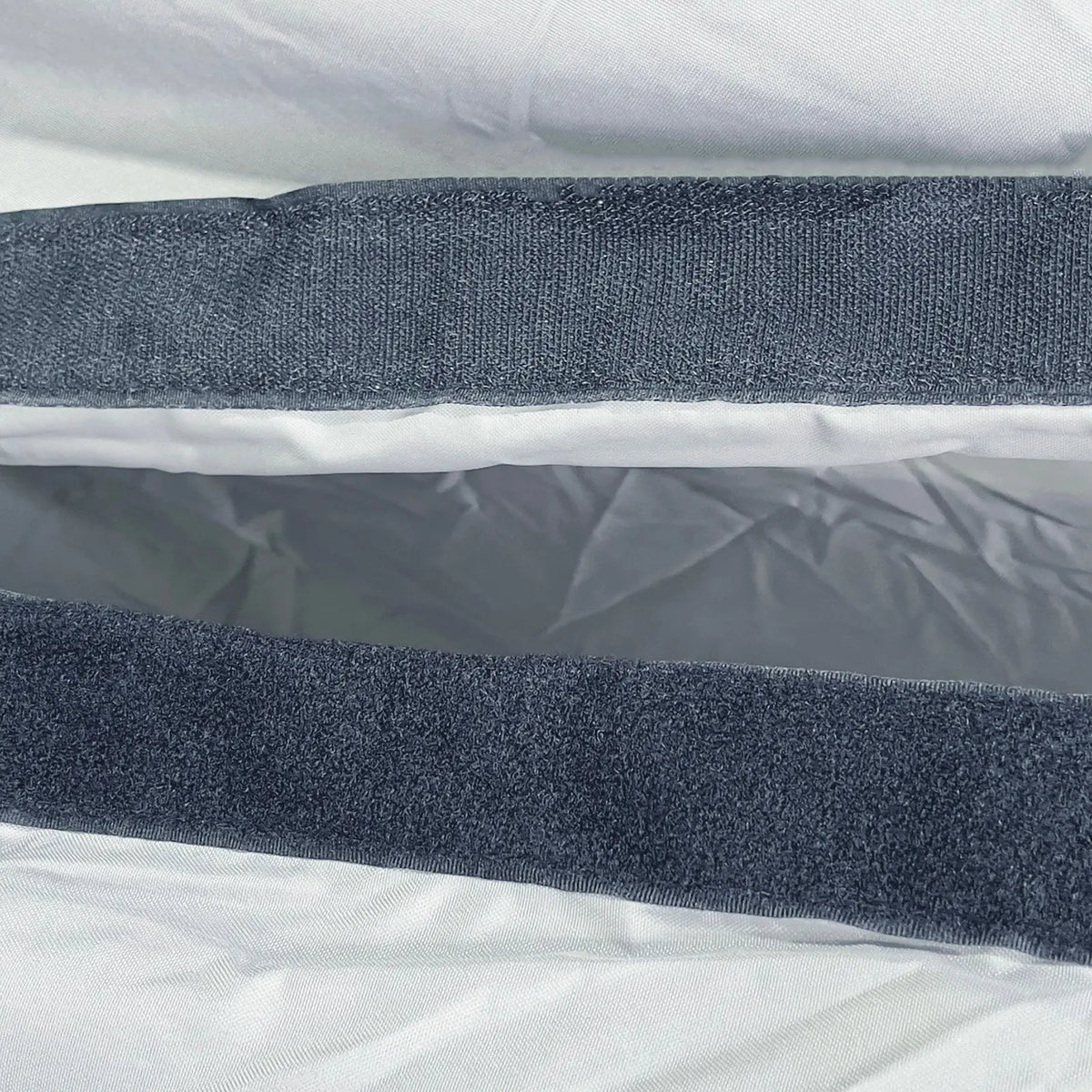 Close-up of the Velcro closure sleeve on the SavvyCraft T-top console cover, designed to securely wrap around antennas, outriggers, and hard top frame mounts.