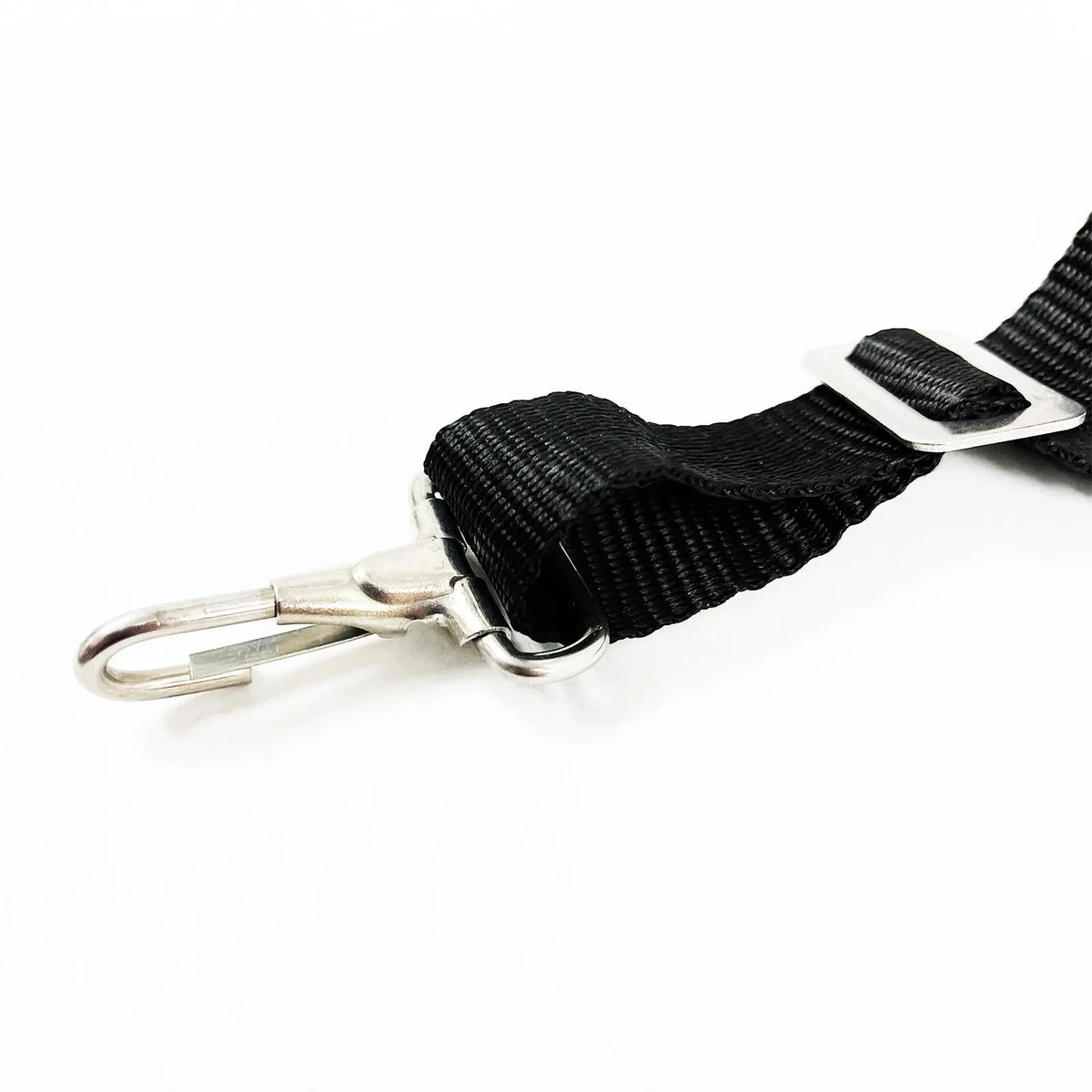 Close up of a metal snap hook on the end of a black webbing strap.