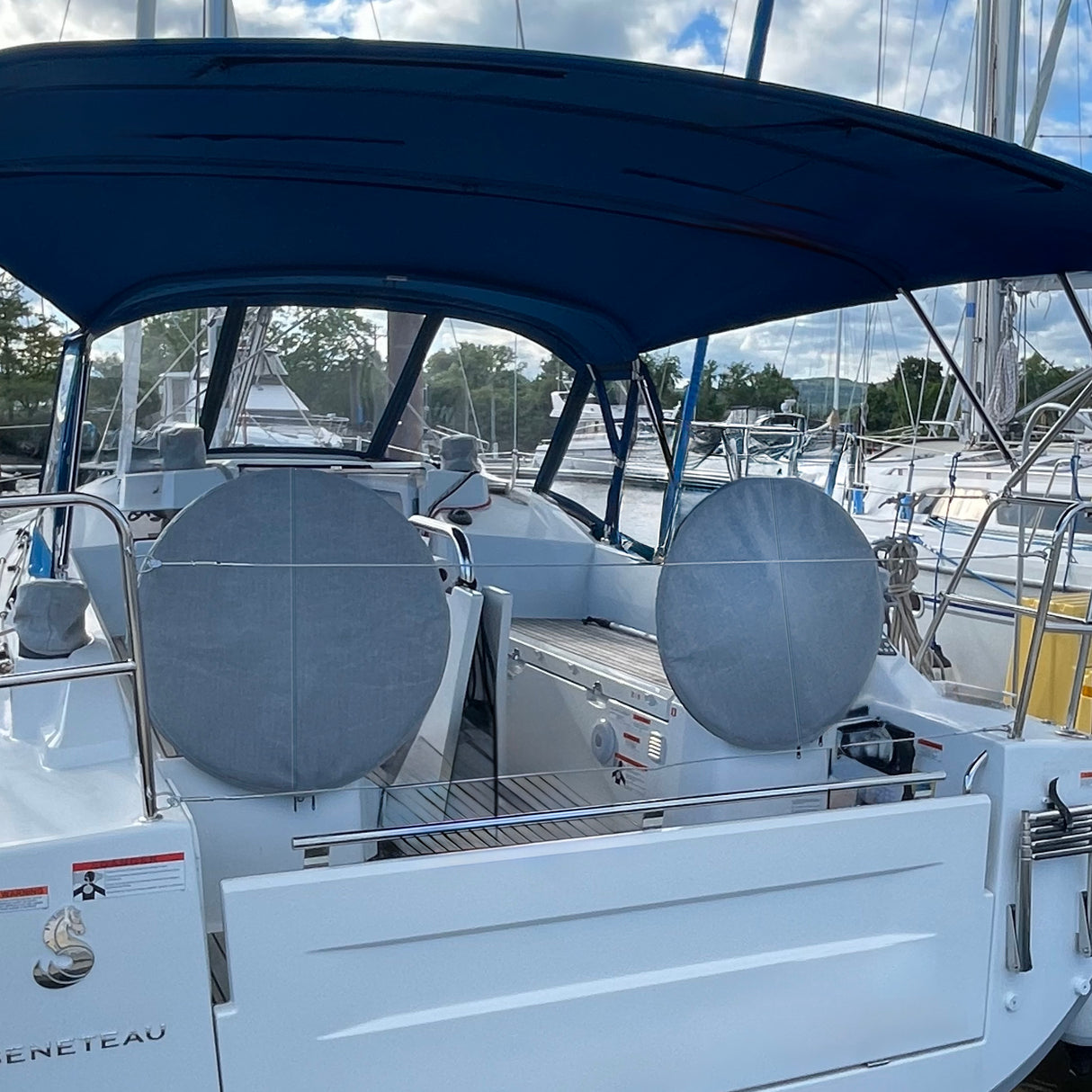 SAVVYCRAFT® grey waterproof boat steering wheel covers installed on a boat with dual helms, protecting against sun, water, and wear in a marine environment
