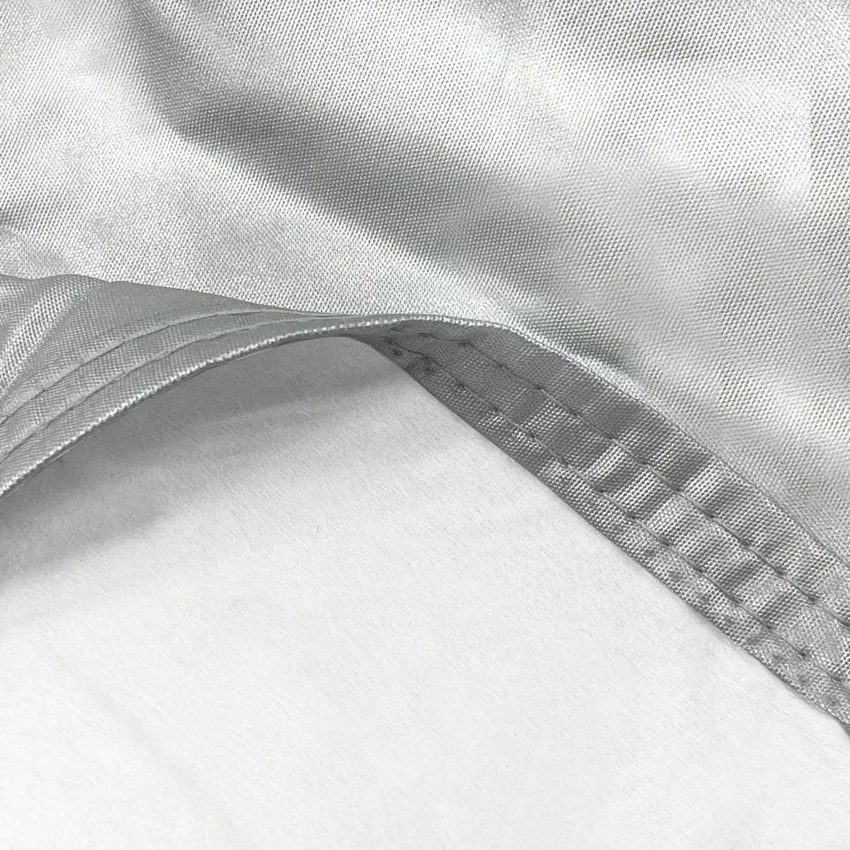 UV-reflective silver polyester fabric with soft fleece lining, waterproof and designed to protect automotive finishes.