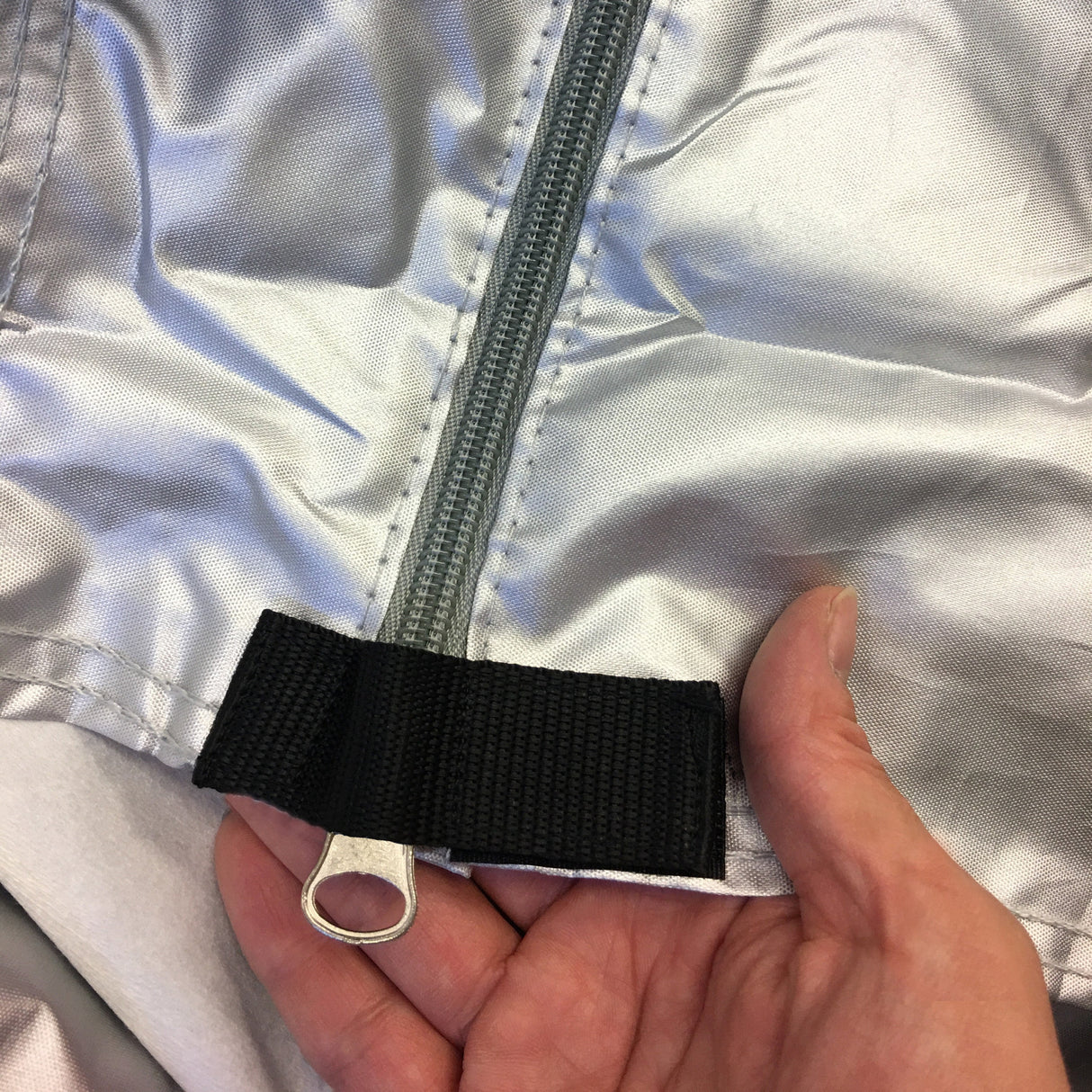Side zipper access with reinforced Velcro stopper for added security.