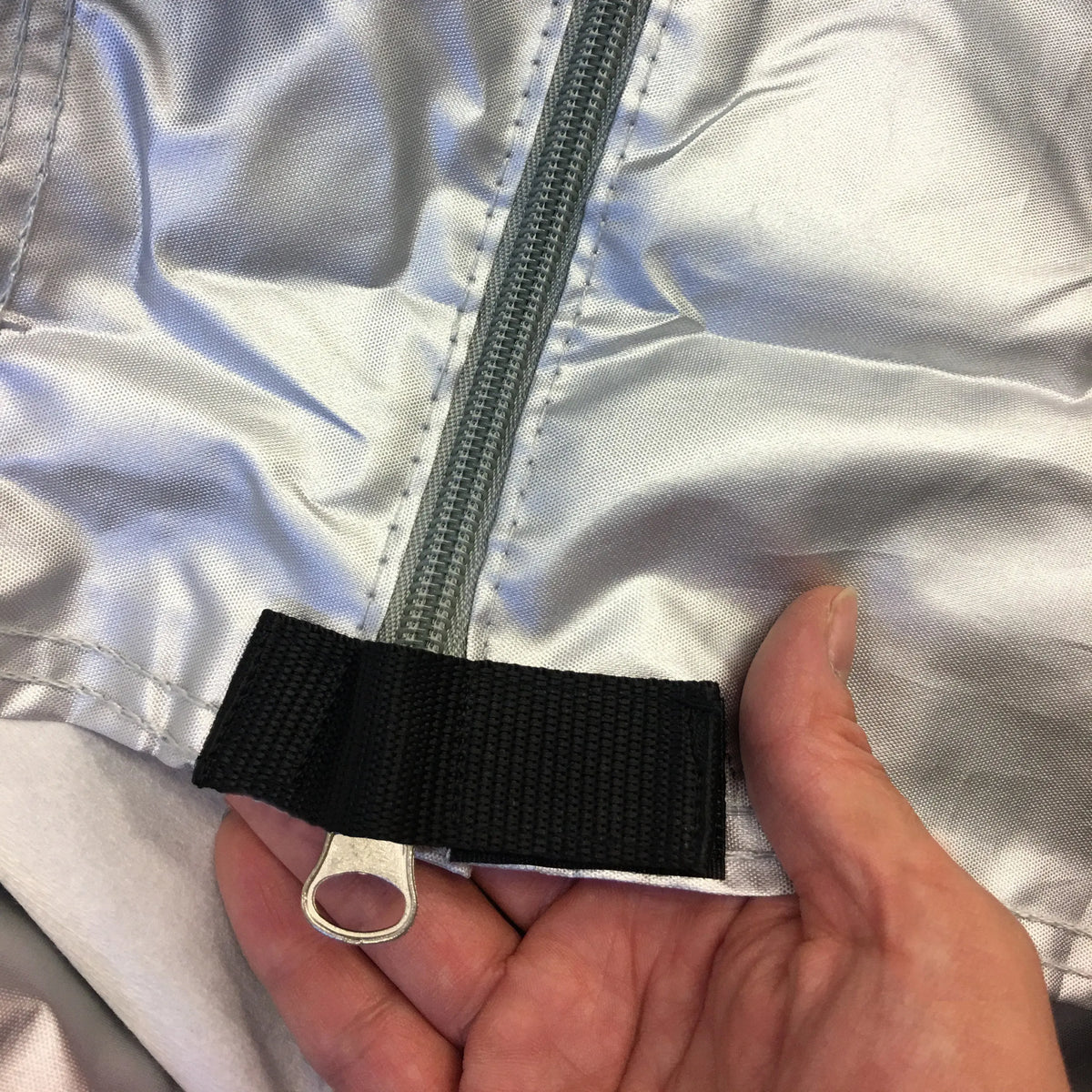 Side zipper access with reinforced Velcro stopper for added security.