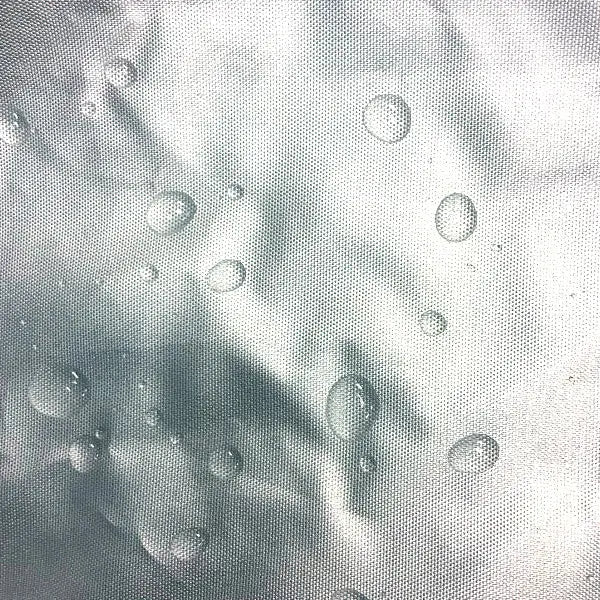 Breathable fabric with water droplets, illustrating moisture release and heat escape to prevent condensation buildup.