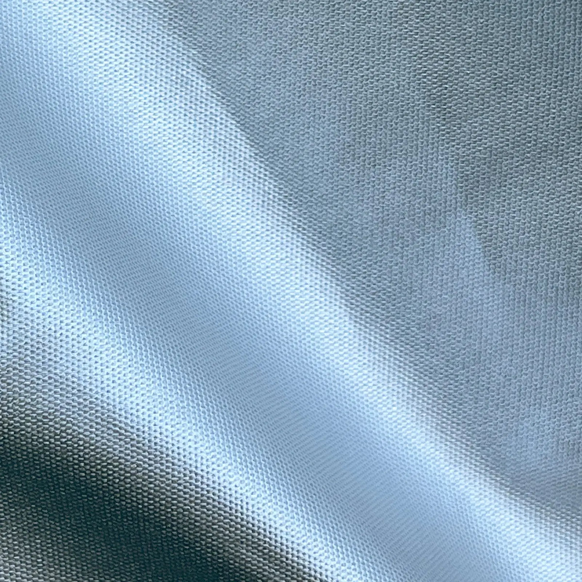 Close-up of water-repellent, marine-grade fabric highlighting UV-treated, all-weather material for motor hood protection, designed to withstand sun, rain, and saltwater exposure
