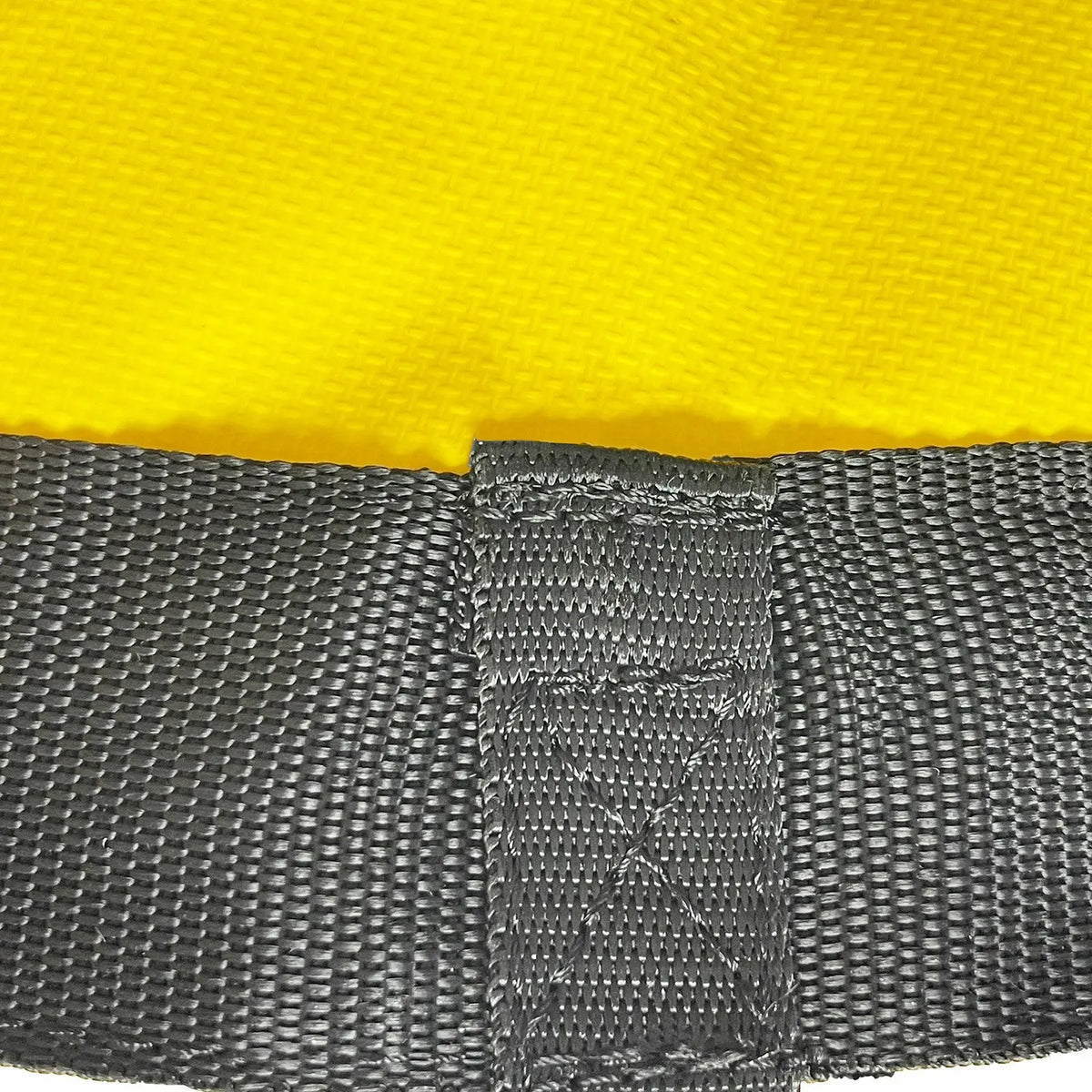 Close-up of yellow nylon drift sock sea anchor with reinforced black webbing and attachment loop for kayak and boat drift control