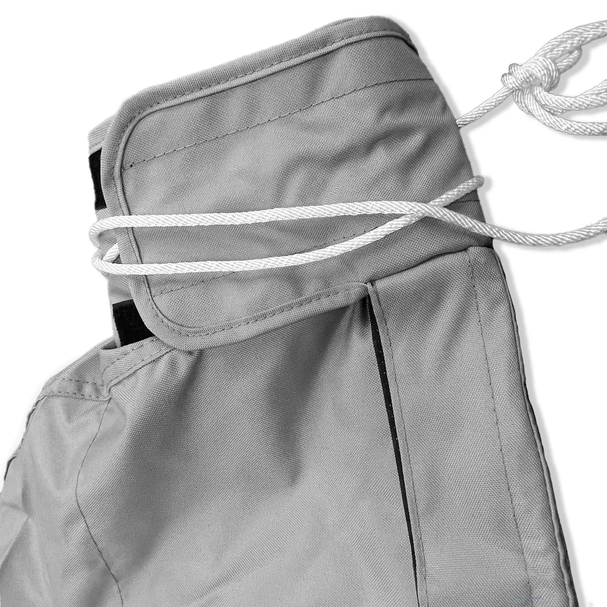 Tie-up string and reinforced top section of waterproof grey sailboat mainsail boom cover
