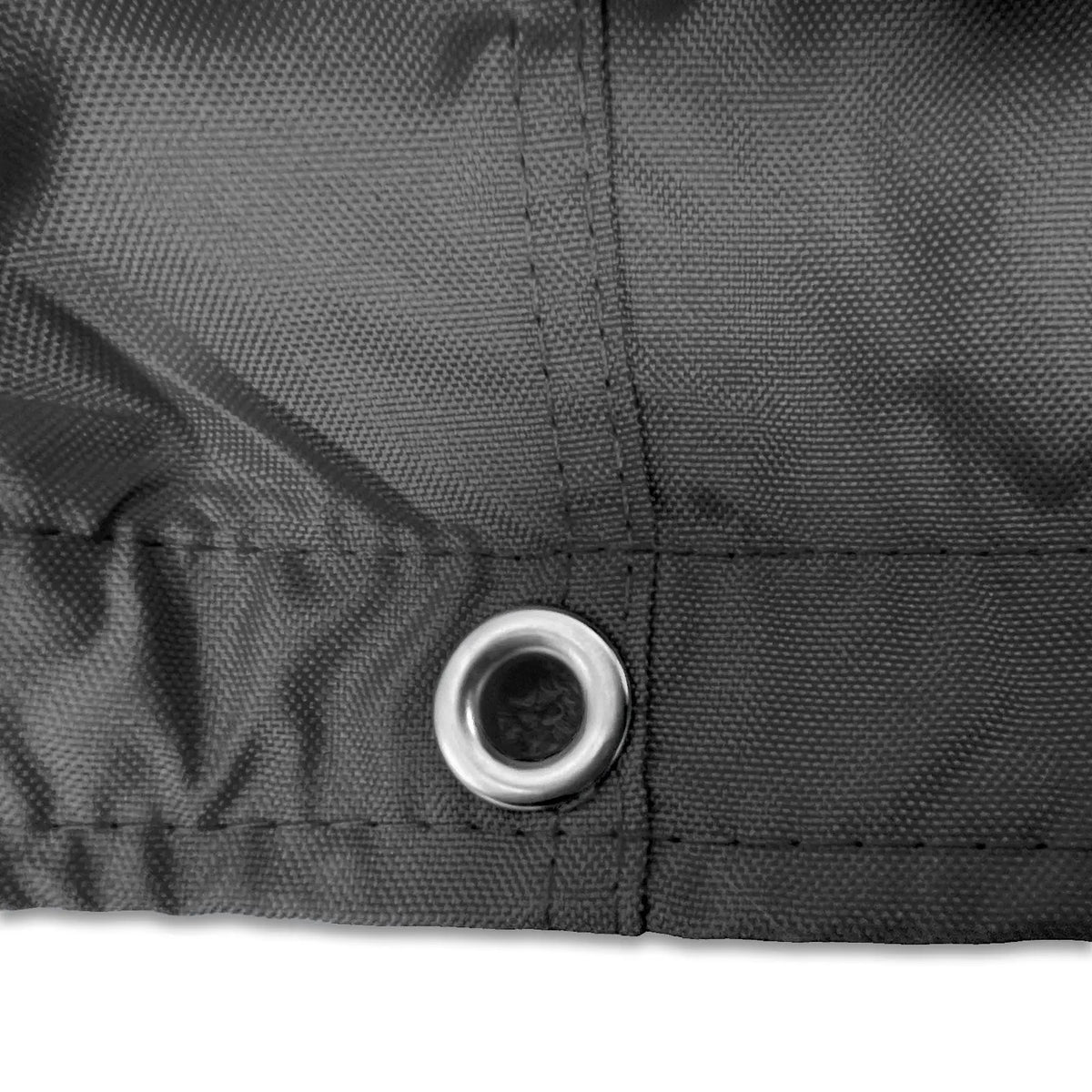 Stainless steel grommet on black waterproof sailboat boom cover for drainage and ventilation