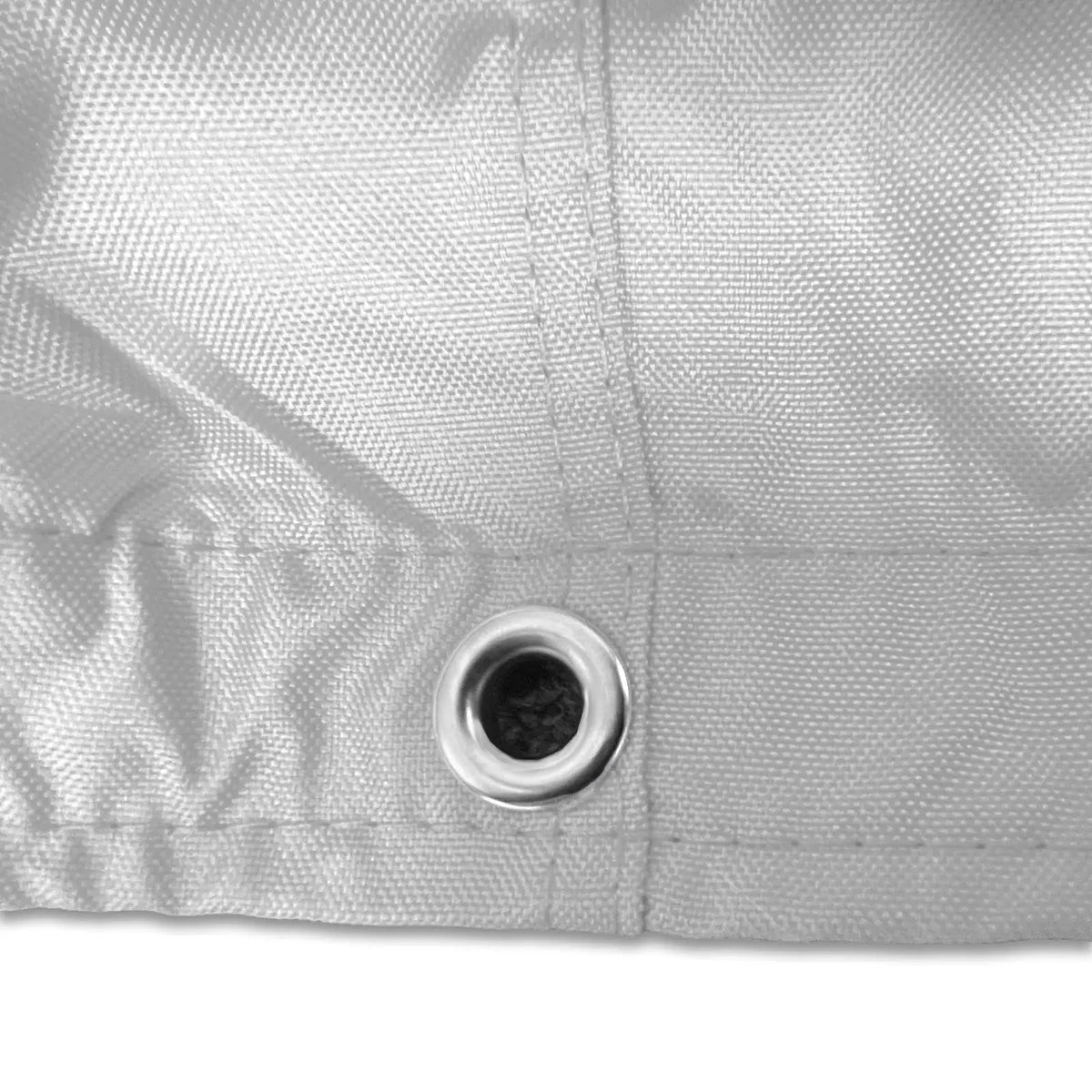 Stainless steel grommet on white waterproof sailboat boom cover for drainage and ventilation