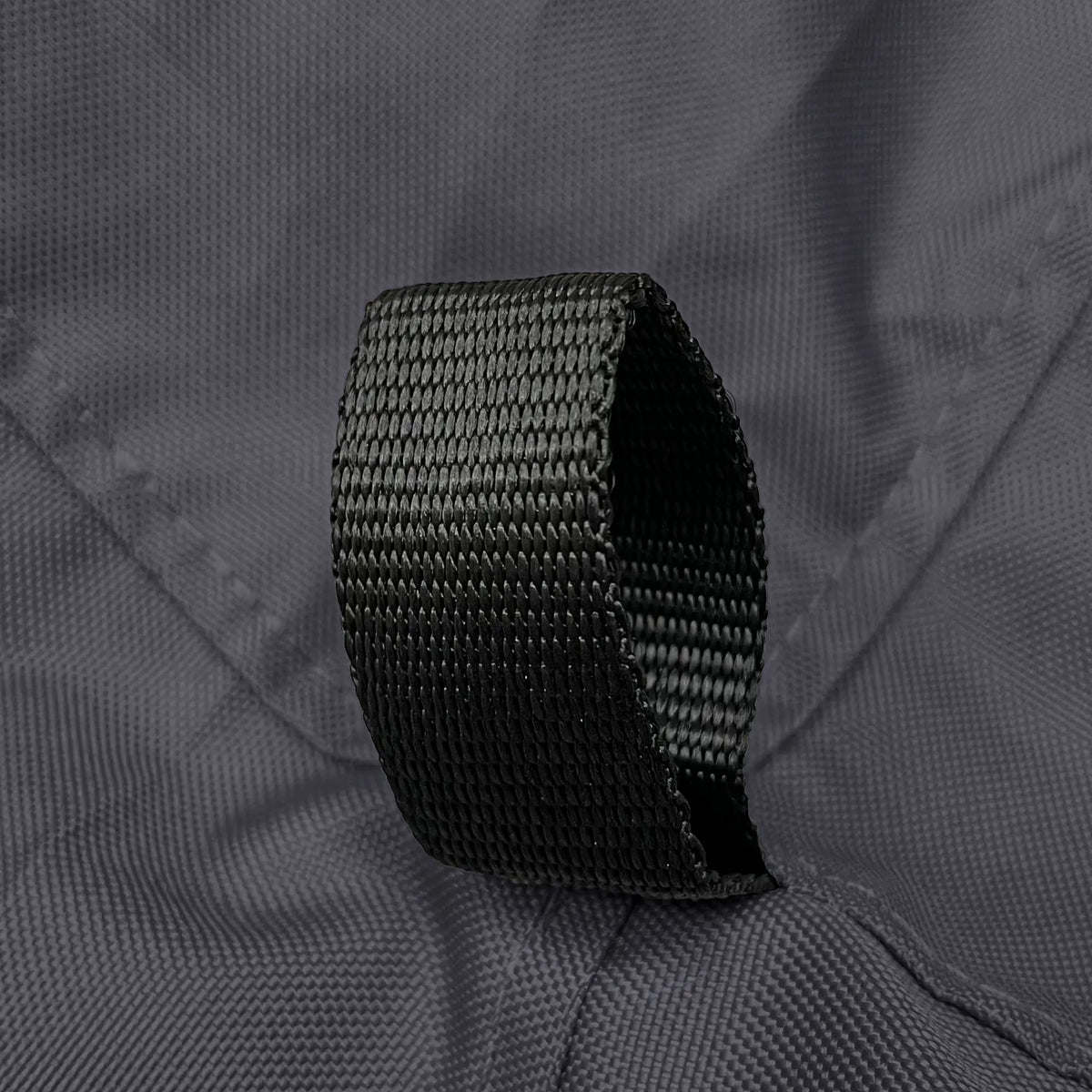 Reinforced black nylon loop securely stitched on durable black polyester fabric, highlighting marine-grade construction and strong attachment point design on sailboat jib sail bag for secure gear handling and long-lasting outdoor performance