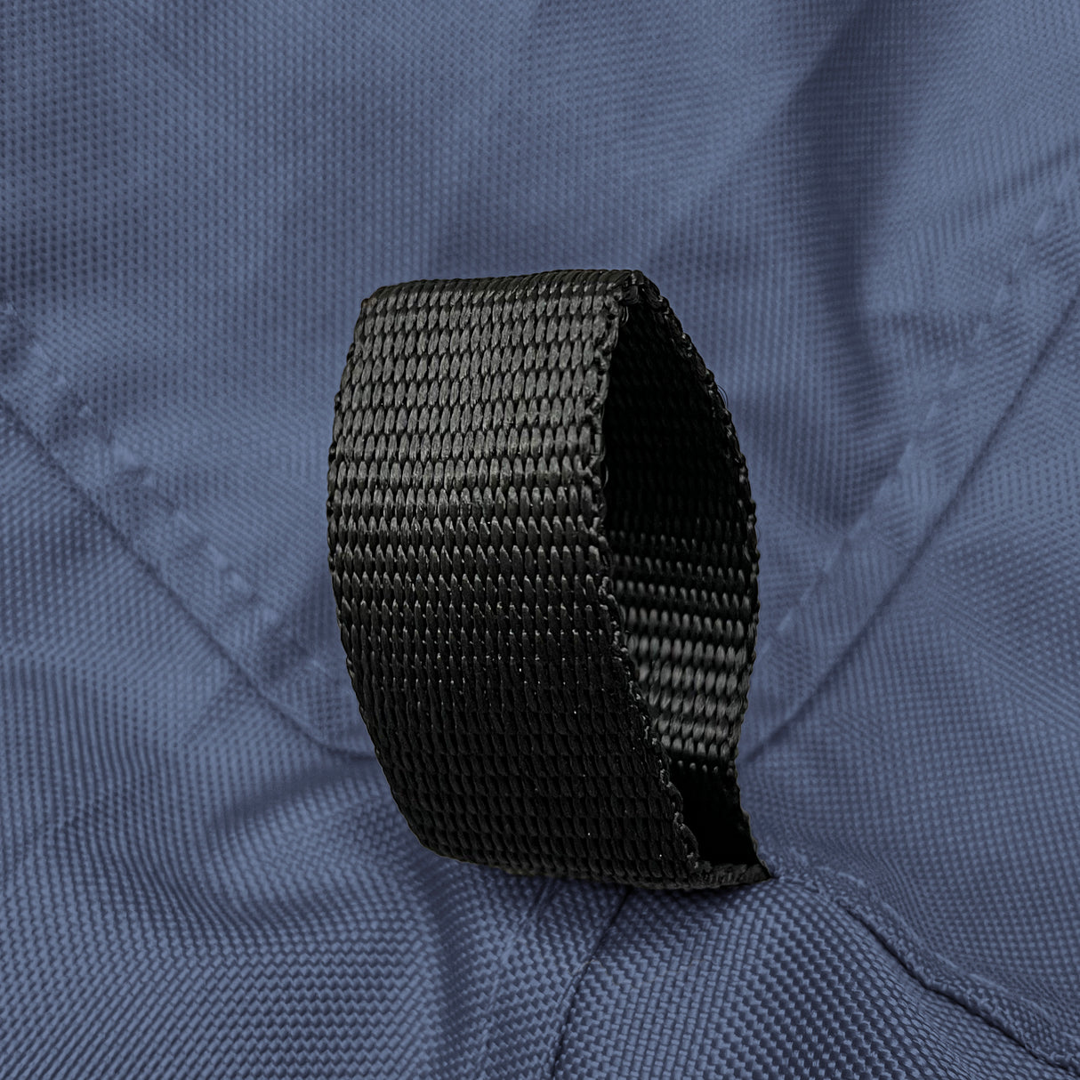 Reinforced black nylon loop securely stitched on durable navy polyester fabric, highlighting marine-grade construction and strong attachment point design on sailboat jib sail bag for secure gear handling and long-lasting outdoor performance