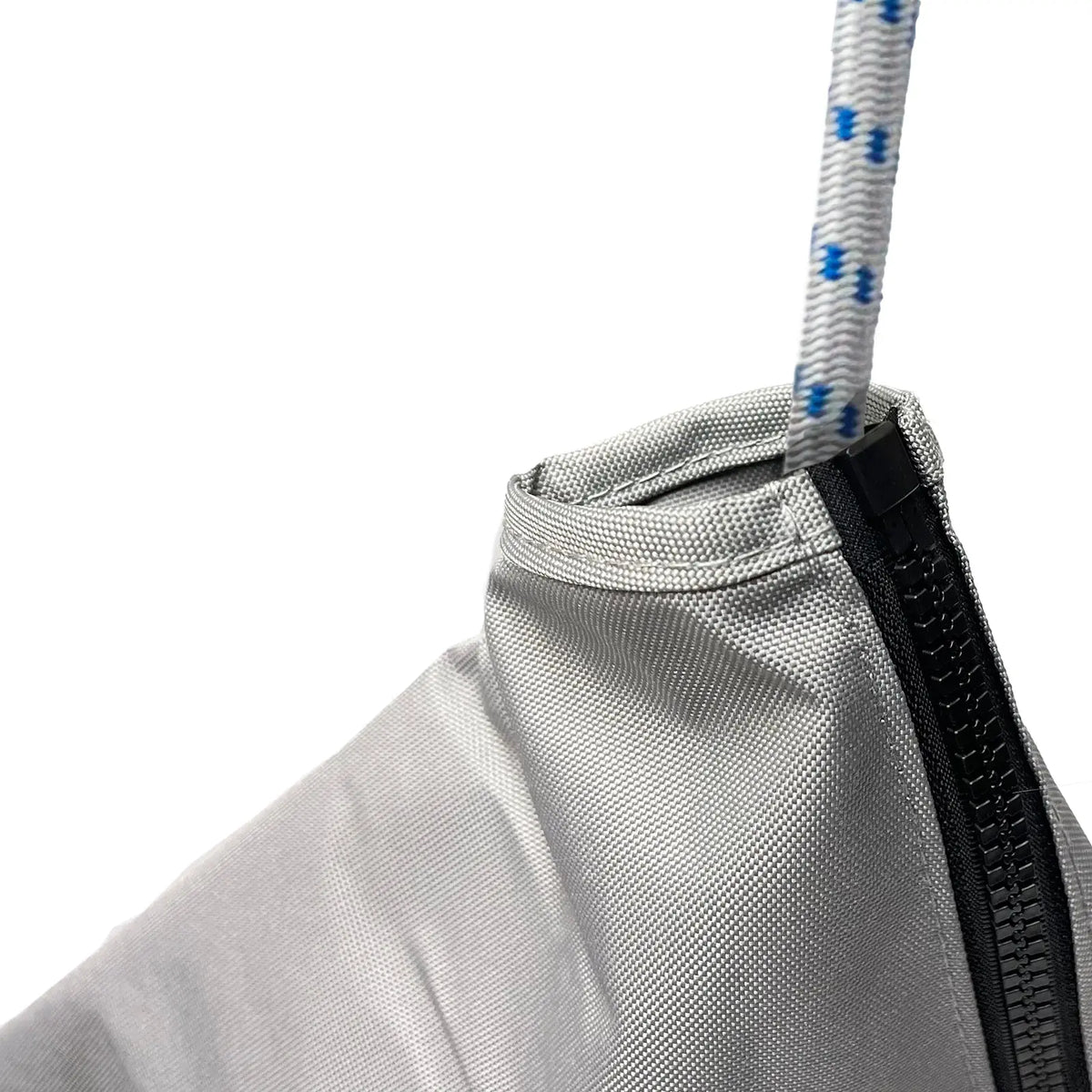 Close-up of waterproof marine-grade sailboat jib sail bag made from heavy-duty grey polyester fabric with reinforced stitching, durable zipper closure, and white rope with blue tracers for secure sail storage and protection in harsh marine weather