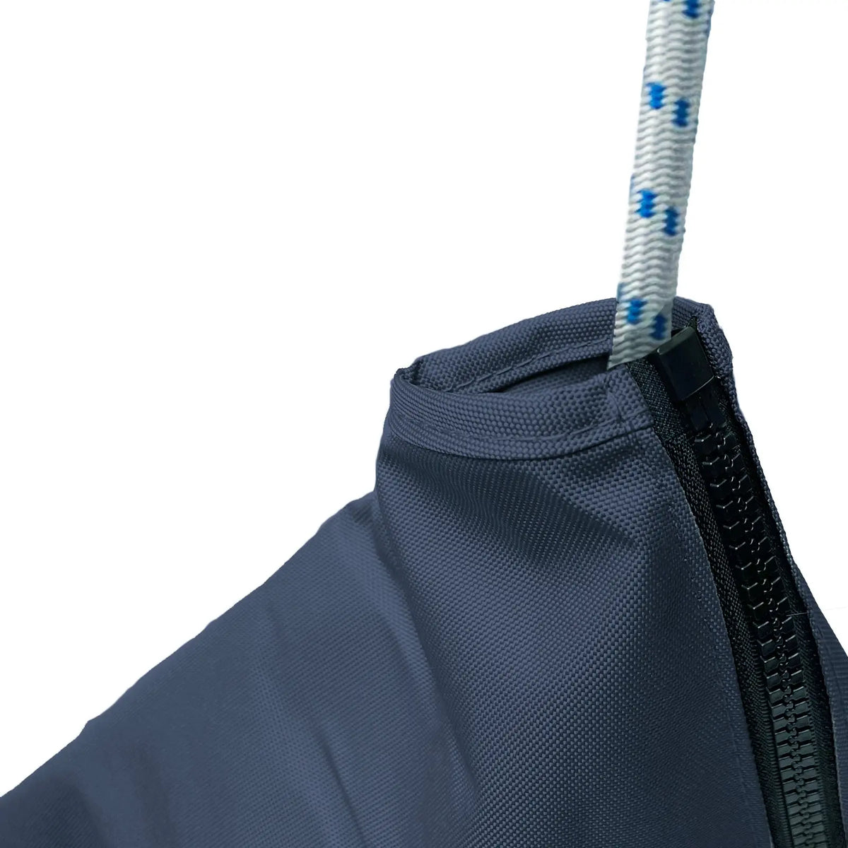 Close-up of waterproof marine-grade sailboat jib sail bag made from heavy-duty navy polyester fabric with reinforced stitching, durable zipper closure, and white rope with blue tracers for secure sail storage and protection in harsh marine weather