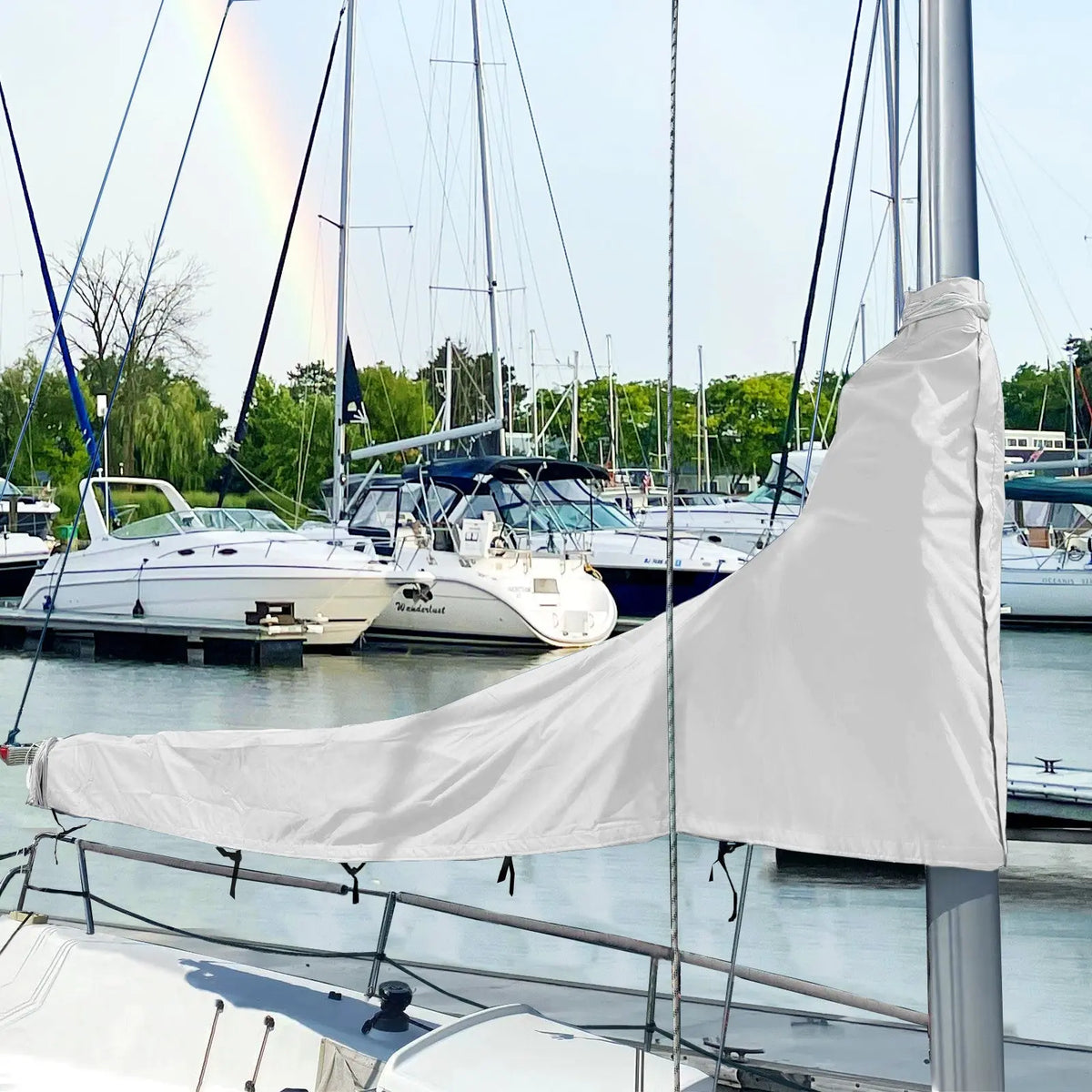 White waterproof sailboat boom cover installed on sailboat at marina