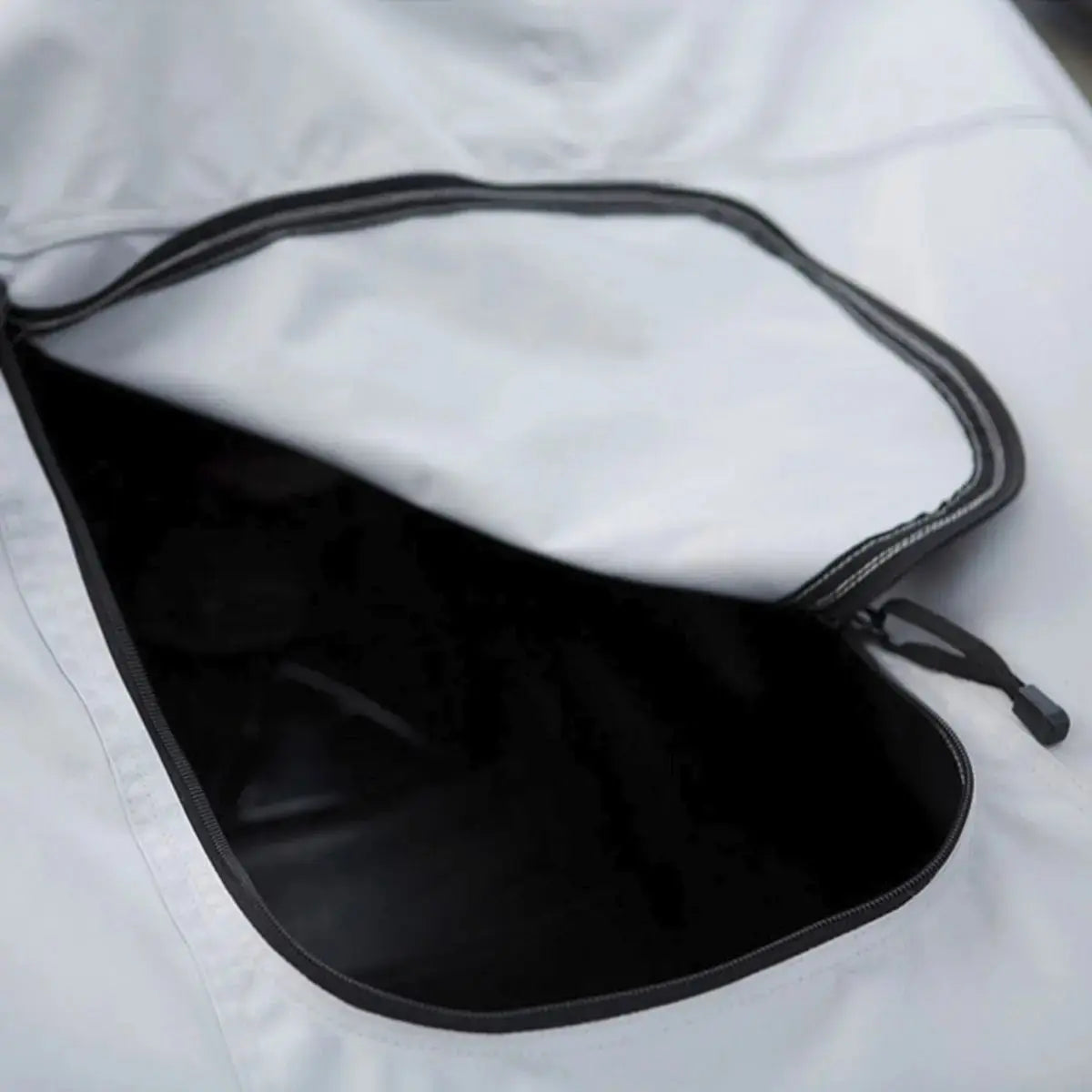 Close-up of white zippered gas tank access built into a snowmobile cover, allowing easy and convenient refueling while the cover remains installed.