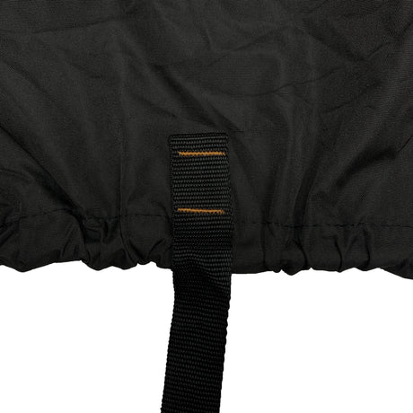 Close-up of strap and elastic hem on a black vehicle cover, designed to secure the cover tightly underneath the vehicle and prevent shifting, flapping, or wind lift during outdoor storage.