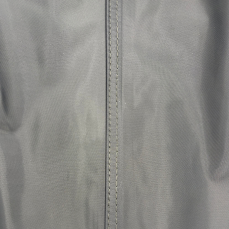 Extreme close-up view of the double-stitched reinforced seam on SavvyCraft green waterproof chest waders, showcasing the durable textile weave and heavy-duty manufacturing.