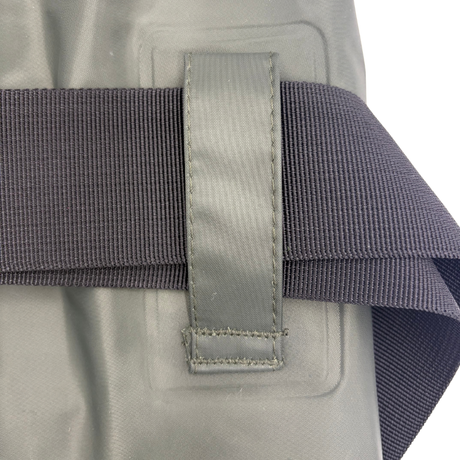 Close-up view of the heavy-duty fabric belt loop on the side of SavvyCraft green waterproof chest waders, securing a thick, dark gray woven wading belt.